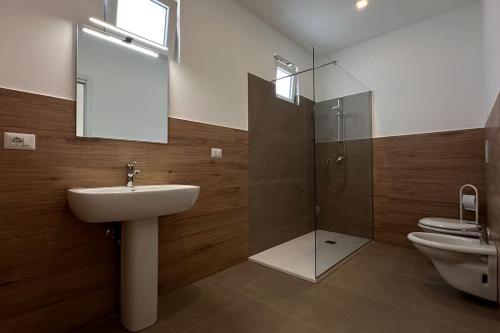 a bathroom with a sink and a shower and a toilet at CconfortHotels Puglia Promenade Apartment 3 in Bari