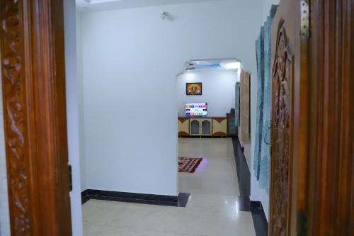 a hallway in a house with a room with a hallway at Nanda Mohan Homestay- Luxuries AC Apartment close to Alipiri Foothills-Kapila Teertham and ISKCON temple in Tirupati