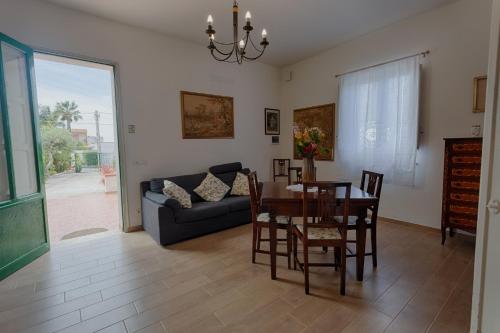 a living room with a table and a couch at Dreamy Apartment with Veranda, Pool and Parking in Rilievo