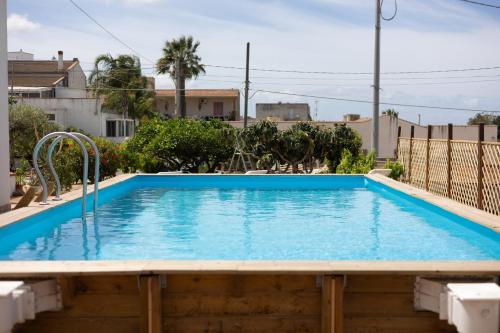 a large swimming pool with blue water in a house at Dreamy Apartment with Veranda, Pool and Parking in Rilievo