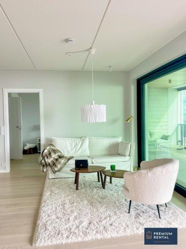 a living room with a white couch and a table at A13 Premium Double room II floor in Hanko