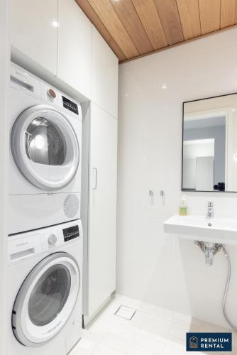 a washing machine in a bathroom with a sink at A13 Premium Double room II floor in Hanko