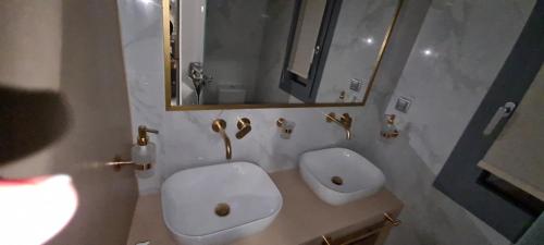 a bathroom with a toilet and a sink and a mirror at Aegean Sunset in Agios Sostis