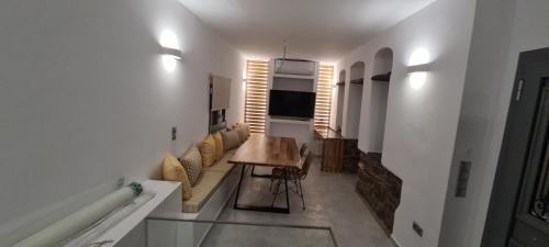 a living room with a table and a couch at Aegean Sunset in Agios Sostis