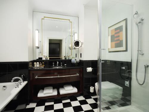 a bathroom with a sink toilet and a shower at Sofitel London St James in London