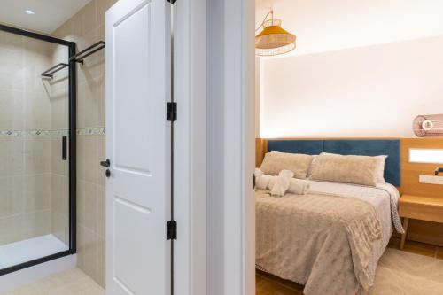a bedroom with a bed and a shower at Apt. Xaramiños Galitrips in Corcubión