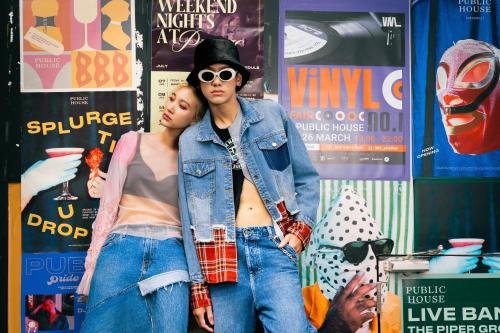 two women standing next to each other in front of a wall at Public House Bangkok, a Member of Design Hotels in Bangkok
