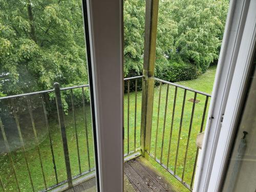 a balcony with a view of a field of trees at 2 Bed Flat - Sleeps 4 - Parking - Wifi in Southampton