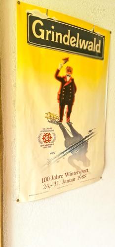 a sign with a man on skis on a wall at Bussalp Apartment - Aare Jungfrau AG in Grindelwald