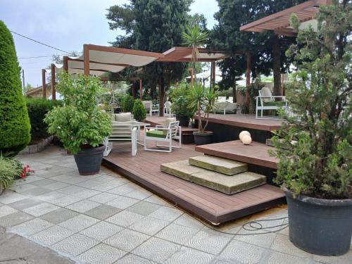 a patio with a table and chairs and plants at GARDEN HOTEL in Broummana
