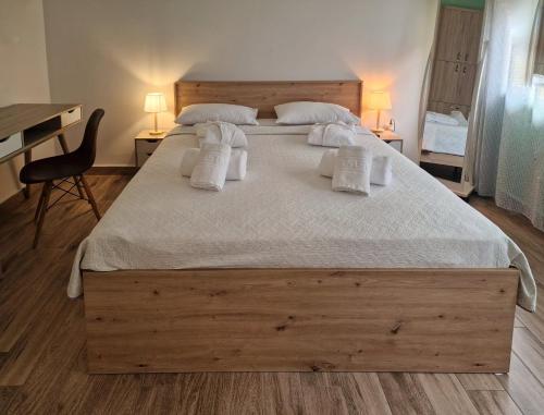 a bedroom with a large bed with white sheets and pillows at Agora Residence in Chios
