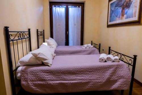 two beds in a room with towels on them at B&B dell'Aviatore in San Liberato