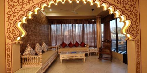 a living room with couches and a brick wall at Neonz Resort & Club in Anand