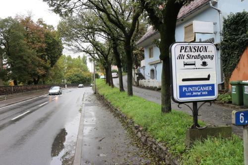 a sign on the side of a street at Pension - Alt - Strassgang in Graz