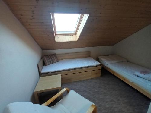 a small room with two beds and a window at Apartmán Svaté Pole in Svaté Pole