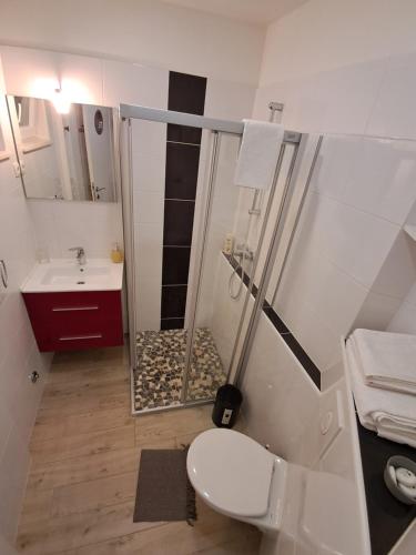 a bathroom with a shower and a toilet and a sink at Apartments Oaza in Split