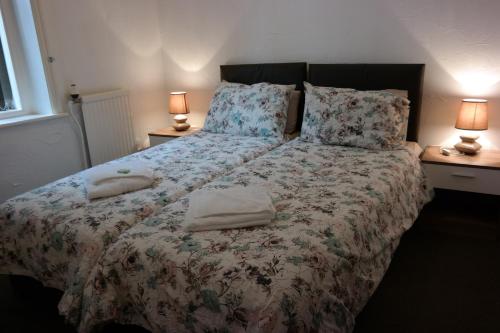 a bedroom with a bed with two pillows on it at Cardoh Lodge in Blackpool