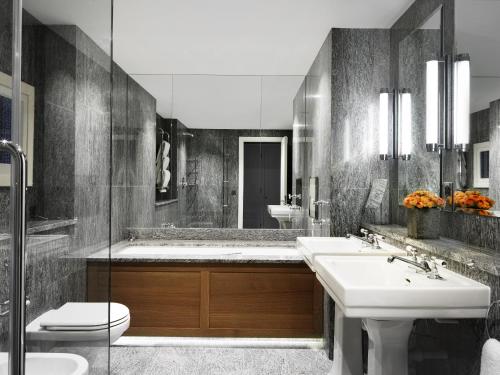 a bathroom with two sinks and a toilet at Charlotte Street Hotel, Firmdale Hotels in London