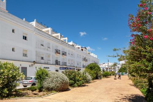 a large white building on the side of a street at Casa Pinto in Vejer de la Frontera