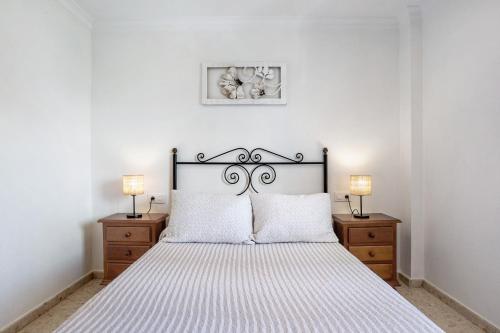 a bedroom with a large bed with two night stands at Casa Pinto in Vejer de la Frontera