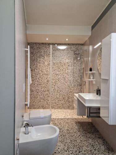a bathroom with a toilet and a sink at Cozy flat mins walk to Navigli and metro Porta Genova in Milan
