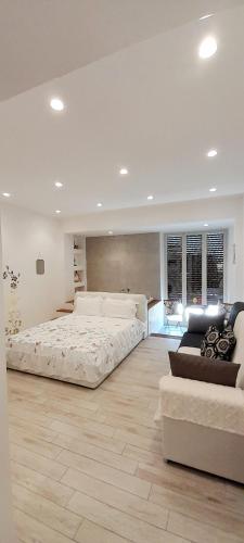a large bedroom with two beds and a couch at BARBARA Classy Apartments 103, Wellness in Siracusa