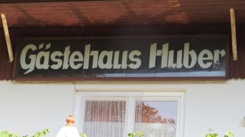 a sign on the side of a building at Gästehaus Huber - traditional Sixties Hostel in Feichten