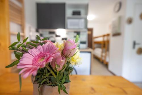 a vase filled with flowers sitting on a table at Les chalets du Praz 4 - Immoclean in Morillon