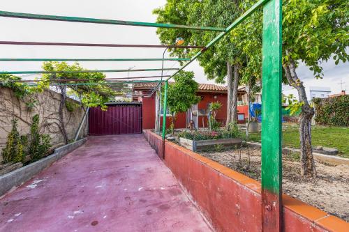 a walkway in front of a house with a garage at Cal Jaume in Masquefa