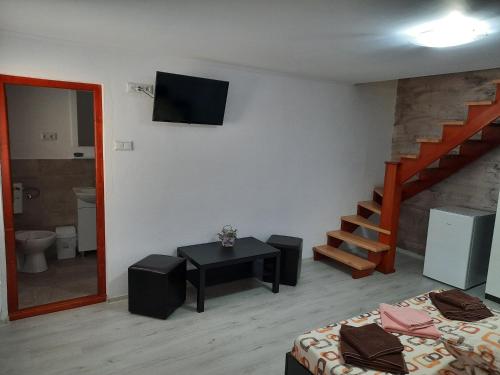 a room with a room with a bed and a staircase at Case de vacanță Gabriel in Sovata