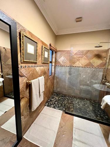 a bathroom with a walk in shower and a sink at Forty 4 On Hoog in Polokwane