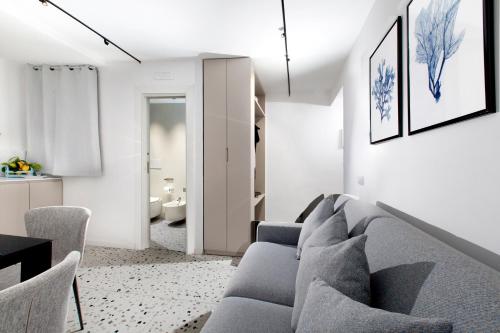 a living room with a gray couch and chairs at Capri House in Capri