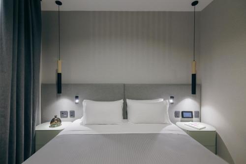 a bedroom with a large bed with two white pillows at Grand Brizo Bel Air in Buenos Aires