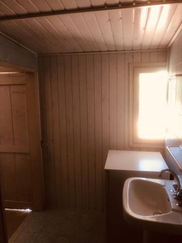 a bathroom with a sink and a window at Barreira Beachfront Rooms 7 in Kalamata