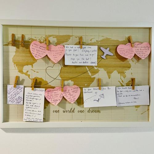 a bulletin board with hearts and notes on a wall at Divjaka Apartments 3 - City Center in Divjakë