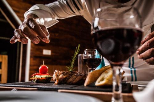 a person is reaching for a glass of wine at My Green Boutique Hotel in Sapanca