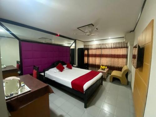 a bedroom with a large bed and a sink at Hotel Dallas Sylhet in Sylhet