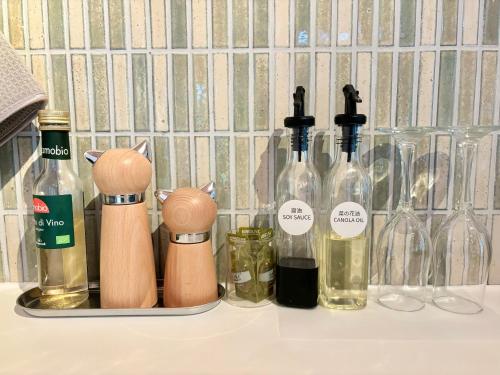 a group of bottles of wine sitting on a counter at まるしっぽ邸-Marushippotei-連泊20パーセントOFF!Onsen,BBQ,hammock,national park,home theater in Murautsuri