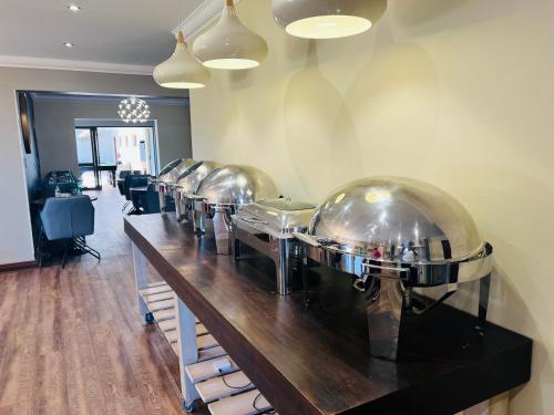 a row of wine bottles lined up on a counter at Omni The Pillar Boutique Hotel in Bloemfontein
