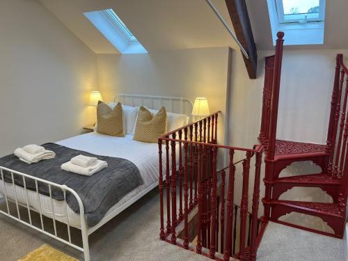 a bedroom with a bed next to a staircase at The Falcon Hotel in Bridgnorth