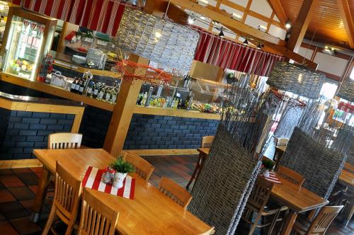a restaurant with wooden tables and chairs and a bar at Ahotel in Czechowice-Dziedzice