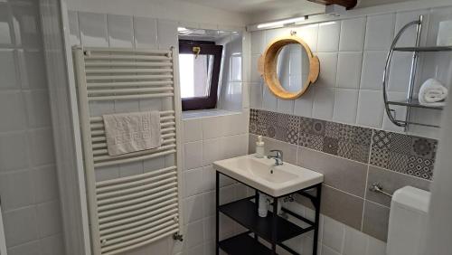 a small bathroom with a sink and a mirror at Puszta Vendégházak 2. in Tiszafüred