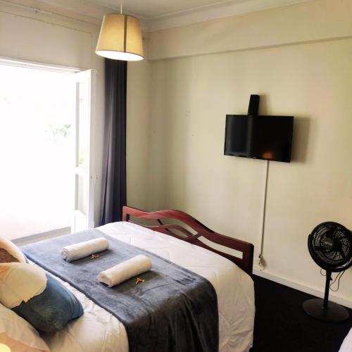 a bedroom with a bed with two towels on it at Liberdade Home Royal direito in Braga