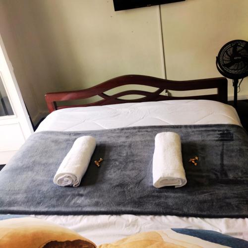 a bed with two pillows on it with at Liberdade Home Royal direito in Braga