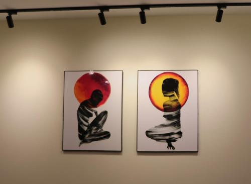 three framed pictures of a woman doing yoga on a wall at Zen Haven by StayMehman in Rawalpindi