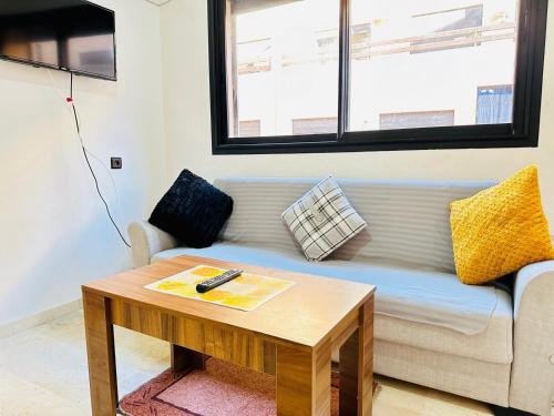 a living room with a couch and a coffee table at NOUR 5 KECH in Marrakech