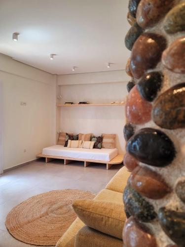 a living room with a couch and a stone wall at Artis Blue Relax in Himare