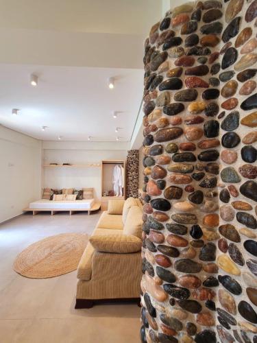 a living room with a stone wall at Artis Blue Relax in Himare