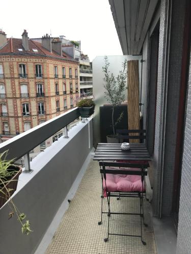 un balcon avec une table et une chaise sur un immeuble dans l'établissement Studio, à Boulogne-Billancourt