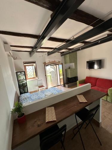 a room with a bed and a desk and a couch at Il Giardino Segreto in Cantalupo in Sabina